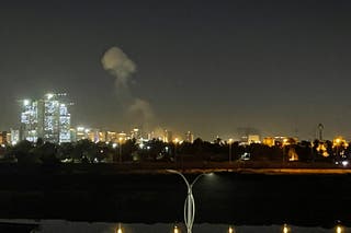 A plume of smoke rises over the Iraqi capital Baghdad on March 16, 2026